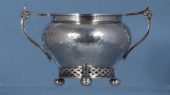 A George V planished silver Arts & Crafts sugar bowl and cream jug, by Albert Edward Jones, jug height 82mm, weight 10.3oz/321grms.
